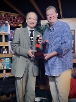 Dr. Wang showing gift with Kevin